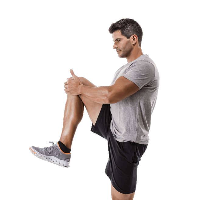 Young, athletic man doing knee stretch before or after exercising.
