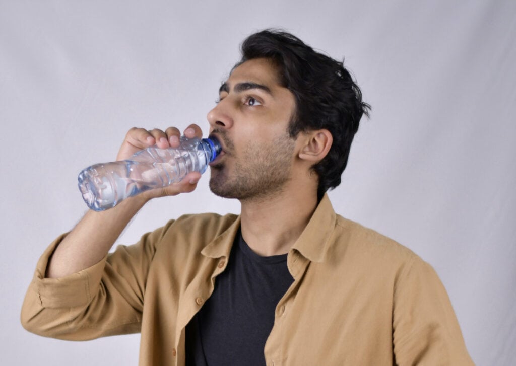 A person drinking water and practicing mindful eating